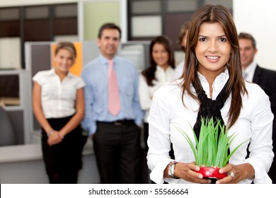 Business Woman Holding A Plant At The Office