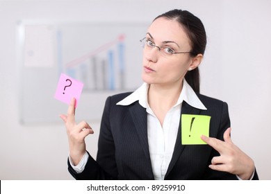 A Business Woman Is Holding Post Its In A Conference Room.