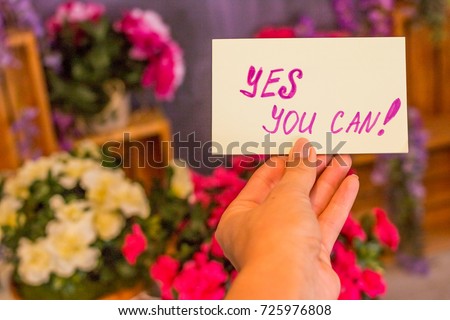 Business woman holding poster yes, you can,  text on it. Positive attitude & encouragement . Make it possible. Motivational concept.Toned image