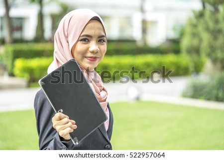 Business woman holding tablet with blur background