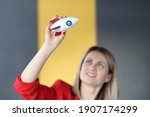 Business woman holding toy rocket in hands in office. New ideas in business development concept