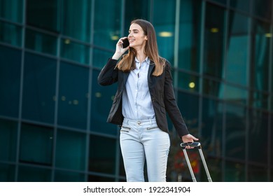 Business Woman At International Airport Talking On The Phone While Moving To Terminal Gate For Airplane Travel Trip - Mobility Concept And Aerospace Industry Flight Connections