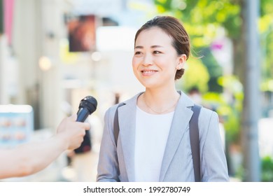 Business Woman Interviewed On The Street 