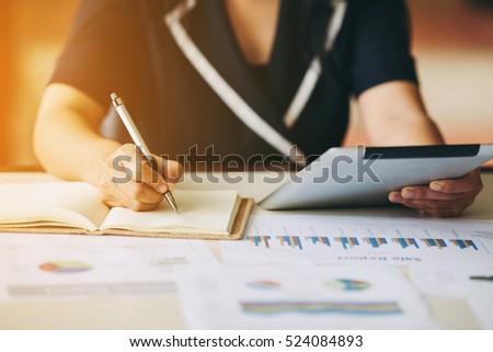 Business woman investment consultant analyzing company annual financial report balance sheet statement working with documents graphs. Concept picture of economy, market, office,money and tax.