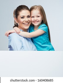 Business Woman With Kid Girl Isolated Portrait Behind White Board. Mother And Daughter Embrace. Female Model.