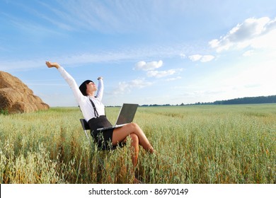 Business woman with  laptop on  agricultural field
