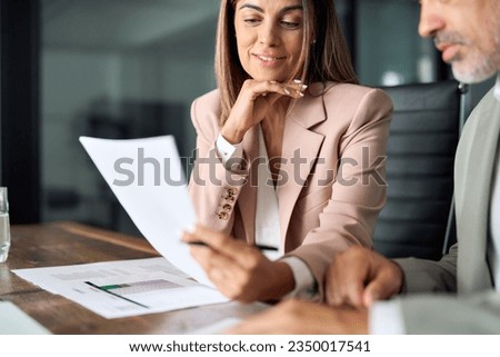 Business woman lawyer attorney showing document to man client providing advisory services, professionals discussing tax papers working in office at meeting. Legal consultancy concept. Close up.