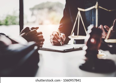 Business woman and lawyers discussing contract papers with brass scale on wooden desk in office. Law, legal services, advice, Justice concept. - Shutterstock ID 1060957841