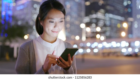 Business Woman Look At Smart Phone In City At Night