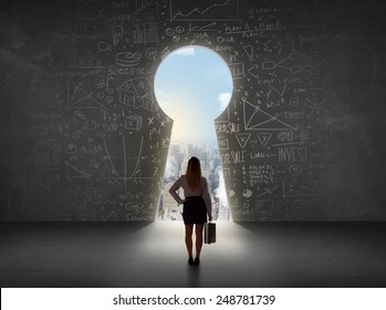 Business woman looking at keyhole with bright cityscape concept background