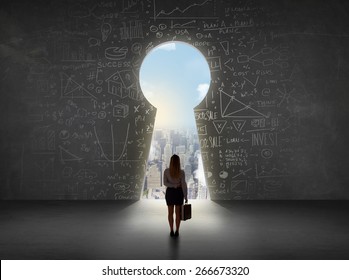 Business woman looking at keyhole with bright cityscape concept background - Shutterstock ID 266673320