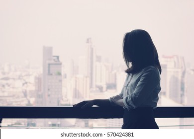 Business Woman Looking Out At The City View With Vintage Filter Background