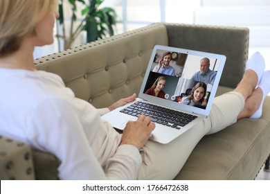 Business Woman Lying On Sofa Speak Talk On Video Call With Colleagues On Online Briefing During Self Isolation And Quarantine. Webcam Group Conference With Coworkers On Laptop At Office.