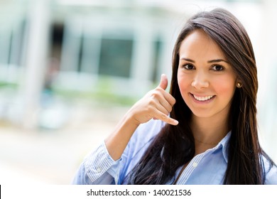 Business Woman Making A Call Me Sign And Smiling