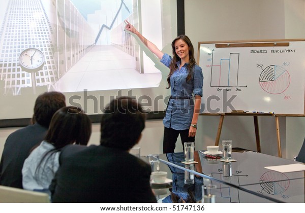 Business woman\
making a presentation at the\
office