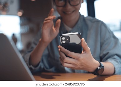 Business woman making video call on mobile smart phone, online meeting during working at coffee shop. Happy woman hipster using smartphone taking self photography, selfie in cafe, people lifestyle - Powered by Shutterstock