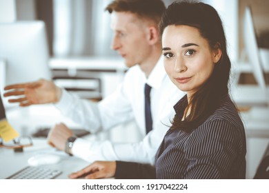 Business Woman And Man Discussing Questions While Using Computer At Workplace In Modern Office. Teamwork, Meeting And Brainstorming Concept