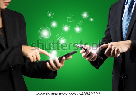 Business woman and business man are sending email by technology digital smart phone green isolated