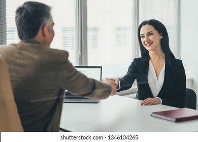 The business woman and a man talking at the office table