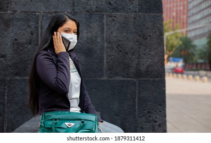 Business Woman With Mask, She Is Sitting Talking On The Phone