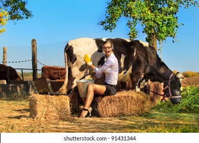 Business Woman Milking Cow On Farm