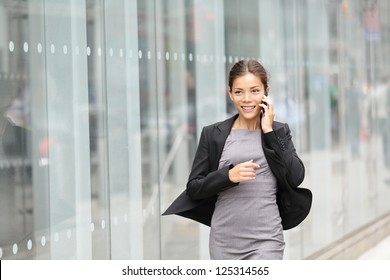 Business Woman In Motion, Talking On Mobile Smart Phone Running Outside On Manhattan, New York City. Beautiful Young Professional Businesswoman. Multiethnic Asian Chinese And Caucasian Ethnicity.