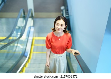 Business Woman Moving On An Escalator