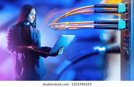 Business woman near server equipment. Telecommunication technologies. Businesswoman with laptop. Woman owner IT company. Girl uses server equipment. Girl manager IT corporation. Fiber optic network - Powered by Shutterstock