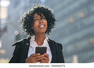 Business Woman In New York City Texting On Cell Phone