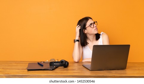 Business Woman In A Office Having Doubts While Scratching Head