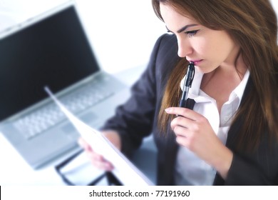 Business woman in an office with laptop