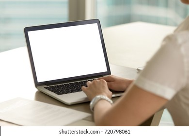 Business Woman In Office Working On Laptop With Mockup Blank Screen. Empty Copy Space On Monitor For Business Advertisement, Corporate Website, Company Financial Report. Close Up View Over Shoulder.