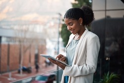 Business Woman On A Digital Tablet Outside A Modern Office Alone. Smiling Corporate Worker Looking At Web And Social Media Posts On A Balcony. Female Employee On A Touchscreen Device With Copy Space