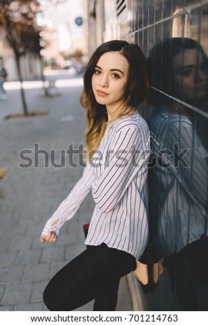 Similar – young girl standing near old building with wires