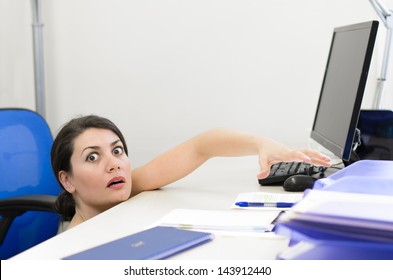 Business Woman Peeking Over The Desk