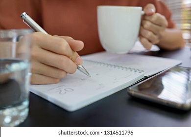 Business woman planning agenda and schedule using calendar event planner.  - Shutterstock ID 1314511796