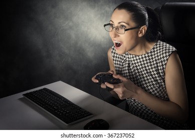 Business Woman Playing Computer Games On A Dark Background.