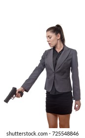 business woman pointing a gun down at something on the ground