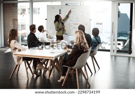 Business woman, presentation and whiteboard in an office for training, meeting or workshop. Men and women at table to listen to speaker, coach or manager talking about strategy, planning or pitch