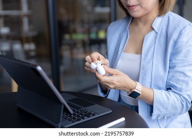 Business Woman Putting On Wireless Headphones, Getting Ready For A Call.