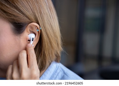 Business Woman Putting On Wireless Headphones, Getting Ready For A Call.