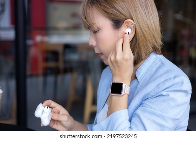 Business Woman Putting On Wireless Headphones, Getting Ready For A Call.