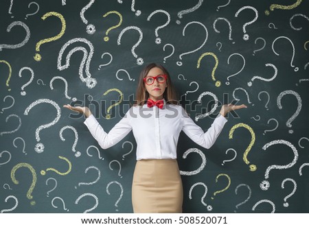 Business woman with question mark on a blackboard