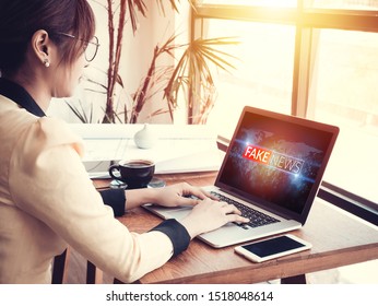 Business Woman Reading Fake News Or HOAX On Internet Content Via Laptop At Workplace