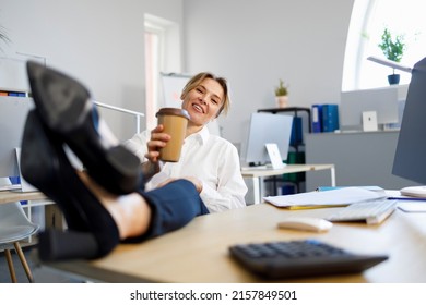 Business Woman Relaxing During Coffee Break Putting Legs On The Desk