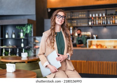 Business Woman Restaurant Owner With Laptop In Hands Dressed Elegant Pantsuit Standing In Restaurant With Bar Counter Background Caucasian Female Glasses Business Person Indoor