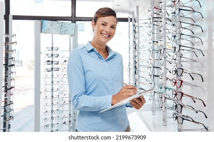 Business Woman, Retail Manager Or Optometrist Employee Writing, Planning And Getting Ready To Service, Work Or Open Retail Store. Smile Portrait, Happy And Success Glasses Store Worker With Clipboard