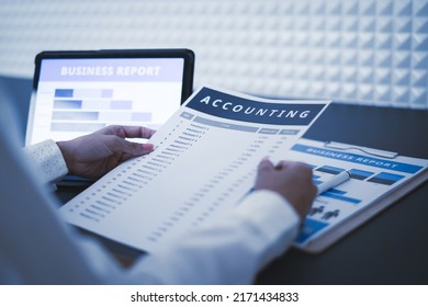 Business Woman Reviewing Data In Financial Charts And Graphs On Wooden Desk In Office And Business Working, Tax, Accounting, Statistics And Analytic Research Concept