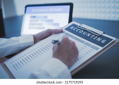 Business Woman Reviewing Data In Financial Charts And Graphs On Wooden Desk In Office And Business Working, Tax, Accounting, Statistics And Analytic Research Concept