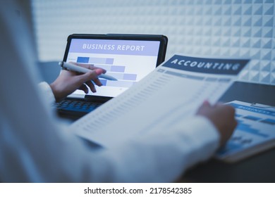 Business Woman Reviewing Data In Financial Charts And Graphs On Wooden Desk In Office And Business Working, Tax, Accounting, Statistics And Analytic Research Concept